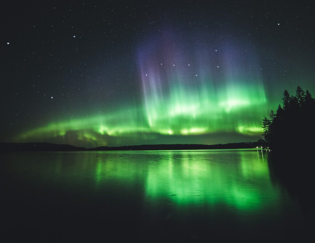 calm body of water under aurora lights Finland