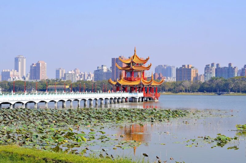 orange pagoda beside beach under clear blue sky