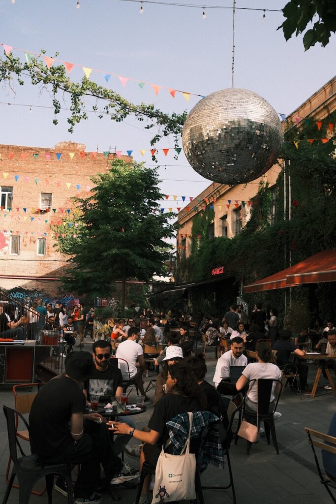 people sitting on chairs near building during daytime