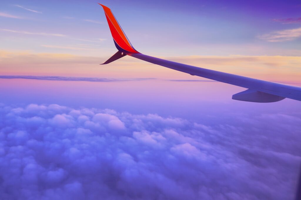 airplane flying in the sunset