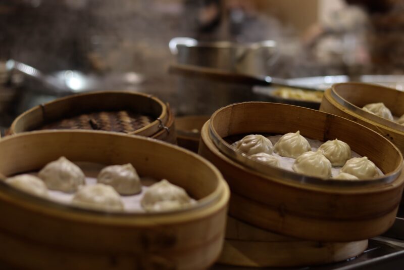 steamed buns on brown wooden steamer