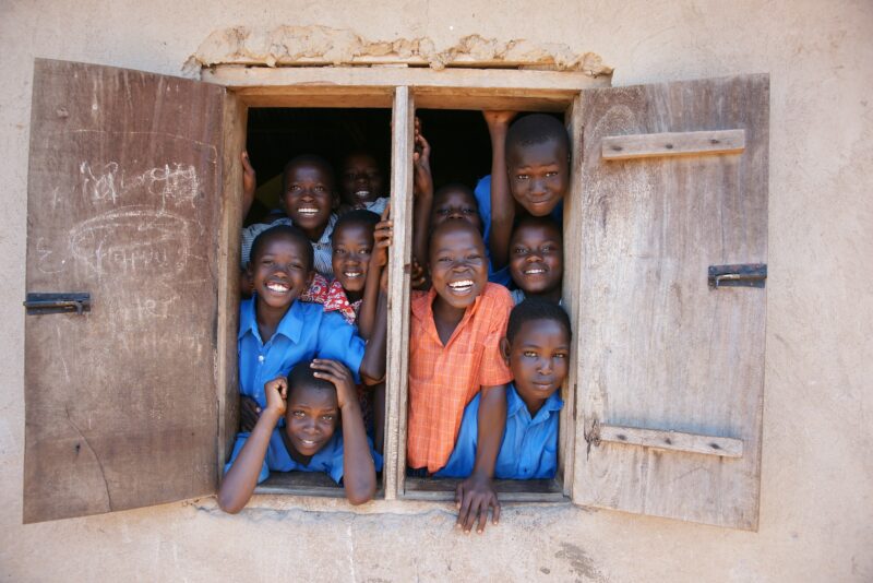 a group of young children standing in a window most hospitable countries in africa