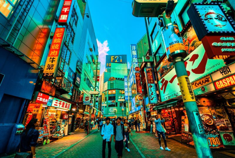 people walking between buildings