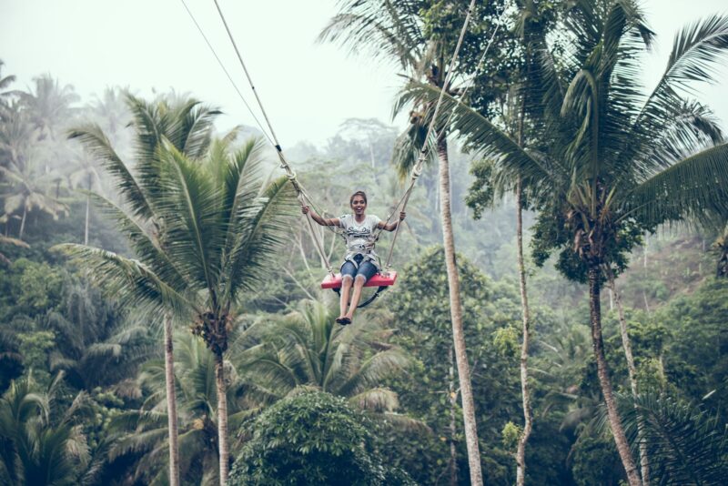 a woman in a tree swing