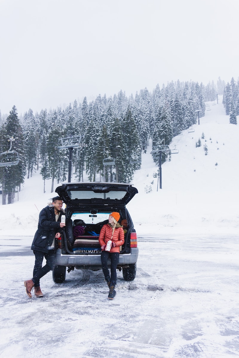 woman with man standing near SUV