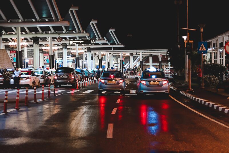 cars on road near station during night