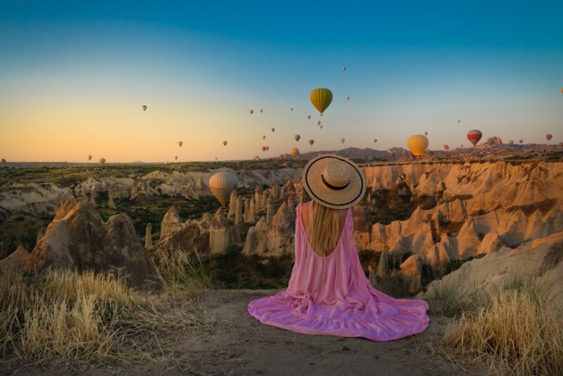 woman sitting near Monument Valley National Park during daytime