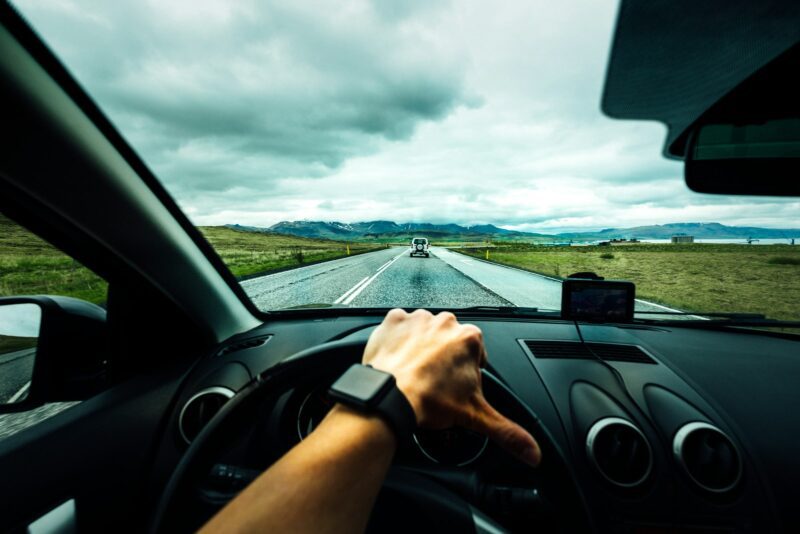 person driving car under clouds