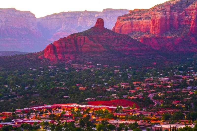 a scenic view of a city surrounded by mountains