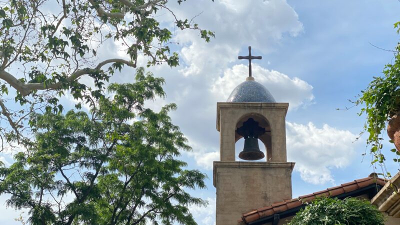 brown concrete church under white clouds during daytime