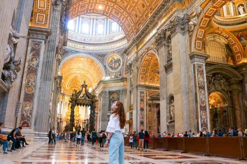 woman standing inside church - solo female travel