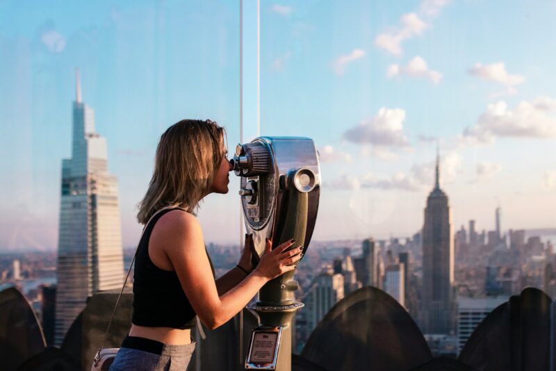 a woman looking through a pair of binoculars