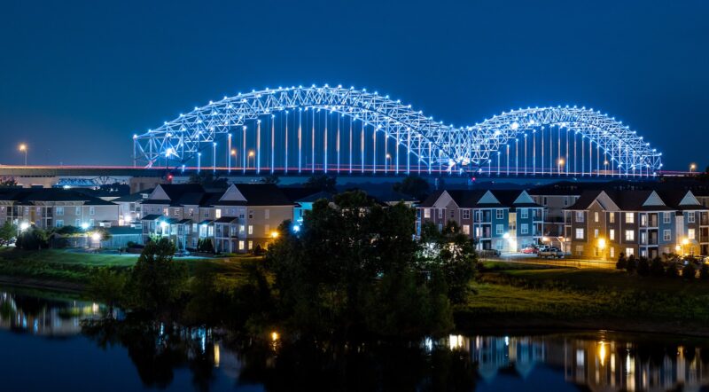 lighted concrete bridge at night