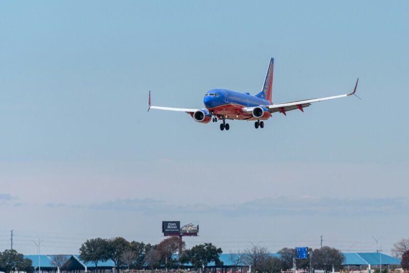 blue and white passenger plane flying during daytime