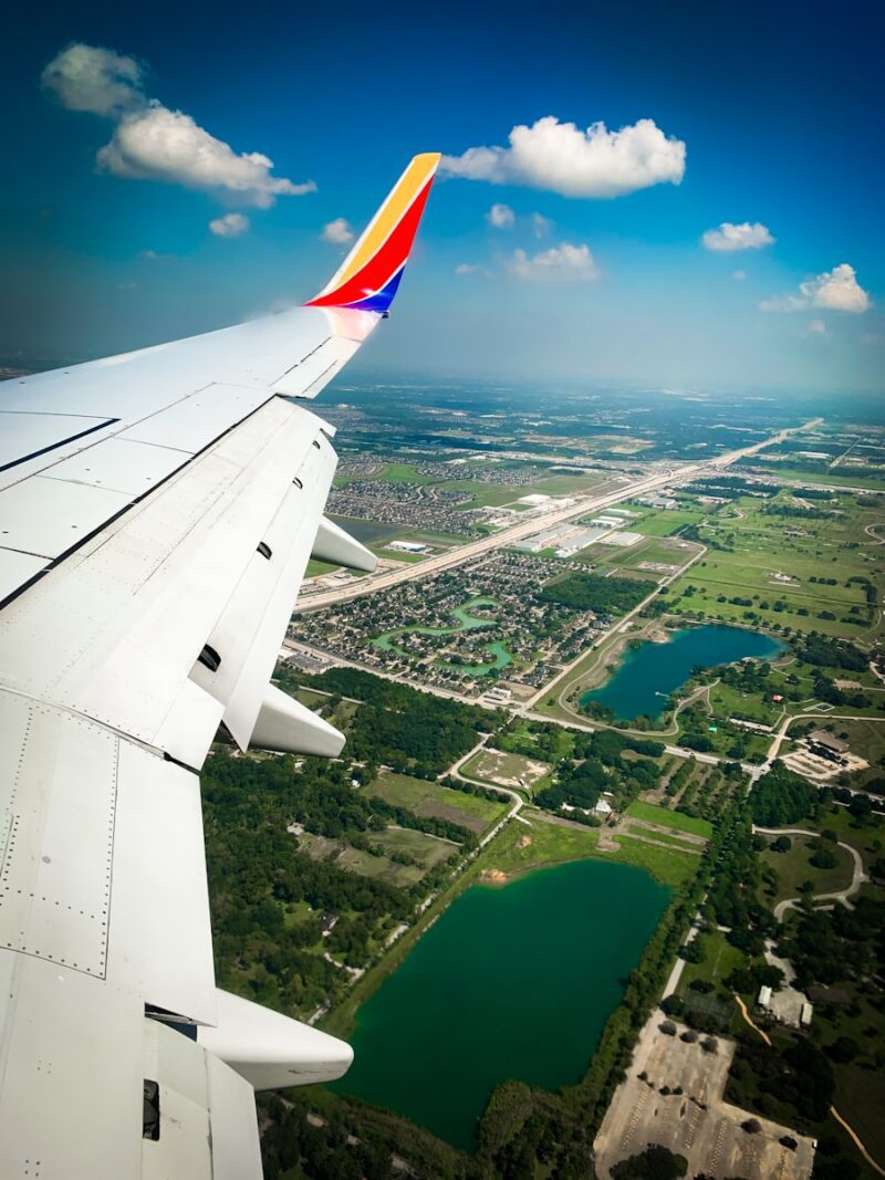 an airplane wing with a river below