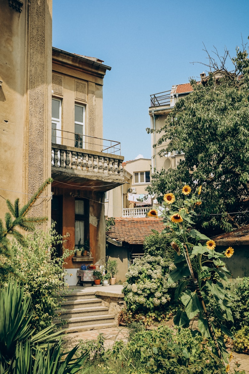 a building with a staircase and plants