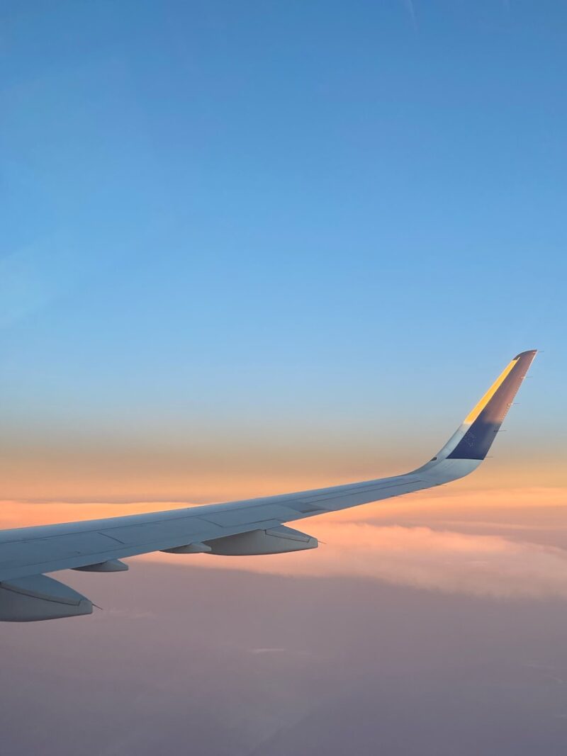 a view of the wing of an airplane in the sky