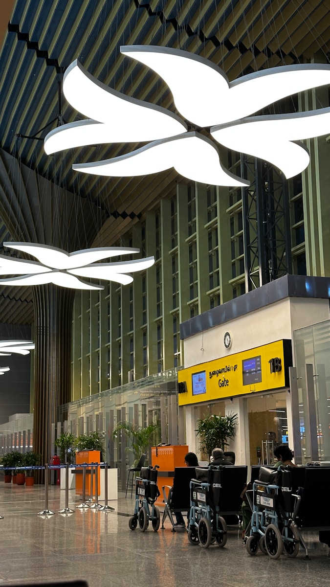 an airport lobby with a bunch of lights hanging from the ceiling